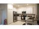 Kitchen with granite countertops, stainless steel appliances and white cabinets at 36439 Garden Wall Way, Zephyrhills, FL 33541