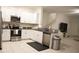 Kitchen boasts stainless steel appliances and white cabinetry at 36439 Garden Wall Way, Zephyrhills, FL 33541