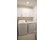Functional laundry room equipped with a washer, dryer, and storage cabinets at 36439 Garden Wall Way, Zephyrhills, FL 33541