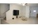Bright living room with stairs and tile flooring at 36439 Garden Wall Way, Zephyrhills, FL 33541
