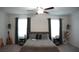 Cozy primary bedroom features neutral gray walls, carpet and large windows for natural light at 36439 Garden Wall Way, Zephyrhills, FL 33541
