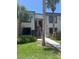 Two-story condo building with a charming entrance and well-maintained landscaping, including palm trees at 376 Moorings Cove Dr # 6C, Tarpon Springs, FL 34689