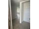 Bright hallway with ceramic tile flooring and neutral paint at 376 Moorings Cove Dr # 6C, Tarpon Springs, FL 34689