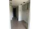 Unfinished kitchen space with tile flooring, plain white walls and an empty cabinet space at 376 Moorings Cove Dr # 6C, Tarpon Springs, FL 34689
