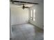 A spacious living room with tile flooring, ceiling fan and a bright window at 376 Moorings Cove Dr # 6C, Tarpon Springs, FL 34689