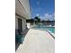 Inviting community pool featuring ample seating, perfect for relaxation and socializing with neighbors at 376 Moorings Cove Dr # 6C, Tarpon Springs, FL 34689