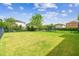 Spacious backyard with well-kept lawn and dark metal fence, ideal for outdoor activities at 4177 Beeswax Ln, Land O Lakes, FL 34638