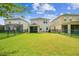 Expansive, well-manicured backyard featuring lush green grass, providing ample space for recreation at 4177 Beeswax Ln, Land O Lakes, FL 34638