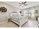 Bedroom featuring light wood floors, neutral paint, and white accents with lots of natural light at 4177 Beeswax Ln, Land O Lakes, FL 34638