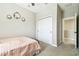 Bedroom featuring carpet flooring and white closet, and floral wreaths on the wall at 4177 Beeswax Ln, Land O Lakes, FL 34638