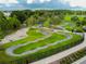 Aerial view of a community bike track featuring looping paths and lush green landscaping at 4177 Beeswax Ln, Land O Lakes, FL 34638