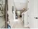 Bright foyer with wood floors, a staircase with white railings, and an open view of the living space with great natural light at 4177 Beeswax Ln, Land O Lakes, FL 34638