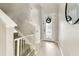 Inviting foyer with wood floors, a staircase, and a decorative glass door showcasing the home's modern design and functionality at 4177 Beeswax Ln, Land O Lakes, FL 34638