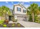 Charming two-story home with a two-car garage, appealing landscaping and beautiful palm trees in the front yard at 4177 Beeswax Ln, Land O Lakes, FL 34638