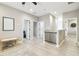 Hallway with light colored wood floors, neutral paint, and multiple doorways with an installed baby gate at 4177 Beeswax Ln, Land O Lakes, FL 34638
