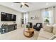 Cozy living room with wood floors, modern furniture, and a large TV, creating a comfortable space for relaxation and entertainment at 4177 Beeswax Ln, Land O Lakes, FL 34638