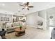 Spacious living room open to the kitchen and dining area, featuring wood floors, recessed lighting, and a neutral color palette at 4177 Beeswax Ln, Land O Lakes, FL 34638