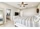 Comfortable main bedroom featuring a dresser with TV and an ensuite bathroom for added convenience at 4177 Beeswax Ln, Land O Lakes, FL 34638