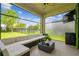 Inviting screened patio furnished with cozy seating, ideal for relaxing and enjoying the outdoor view at 4177 Beeswax Ln, Land O Lakes, FL 34638