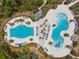 Aerial view of a community pool area featuring a swimming pool and various lounge seating at 4177 Beeswax Ln, Land O Lakes, FL 34638