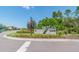 Sign for the Bexley Club community with colorful flowers and landscaping at 4177 Beeswax Ln, Land O Lakes, FL 34638