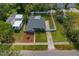 An aerial shot showcases the home's fenced yard, landscaping, and nearby street at 433 Pineapple St, Tarpon Springs, FL 34689