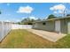 View of the fenced backyard with a small patch of grass and concrete patio at 433 Pineapple St, Tarpon Springs, FL 34689