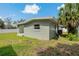 View of the exterior of the home, displaying a small patio and air conditioning unit at 433 Pineapple St, Tarpon Springs, FL 34689