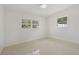 Bright bedroom with two windows, neutral walls, and neutral flooring, providing a relaxing atmosphere at 433 Pineapple St, Tarpon Springs, FL 34689