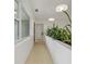 Hallway featuring modern lighting and a built-in planter box with lush greenery at 433 Pineapple St, Tarpon Springs, FL 34689
