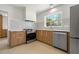 Modern kitchen featuring stainless steel appliances, white backsplash, and sleek wooden cabinetry at 433 Pineapple St, Tarpon Springs, FL 34689