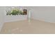 Spacious living room featuring polished Terrazzo floors and white walls, with a view to the front of the house at 433 Pineapple St, Tarpon Springs, FL 34689