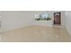 Bright living room with pristine white walls, Terrazzo flooring, and a glimpse of the front door at 433 Pineapple St, Tarpon Springs, FL 34689