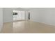 Bright, open living room with seamless Terrazzo floors and an open view to a separate room at 433 Pineapple St, Tarpon Springs, FL 34689