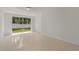 Bright room with Terrazzo floor and glass sliding doors overlooking the fenced backyard and lawn at 433 Pineapple St, Tarpon Springs, FL 34689