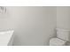 The powder room features a stylish sink and toilet in a minimalist design and neutral colors at 433 Pineapple St, Tarpon Springs, FL 34689