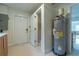 Functional utility room featuring a water heater, shower, and access to both the exterior and interior at 433 Pineapple St, Tarpon Springs, FL 34689