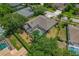 An aerial view of a home with a screened-in pool and well-maintained yard at 4530 Roanoak Way, Palm Harbor, FL 34685