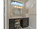 Vanity with marble top, decorative mirror, and stool in this powder room at 4530 Roanoak Way, Palm Harbor, FL 34685