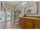 Bathroom featuring granite countertops, glass-enclosed shower, and access to the outdoor pool area at 4530 Roanoak Way, Palm Harbor, FL 34685