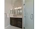 Bathroom features a shower and vanity with a marble countertop and dark cabinets at 4530 Roanoak Way, Palm Harbor, FL 34685