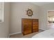 Bedroom with wooden dresser and decorative nautical wheel, adding a touch of coastal charm at 4530 Roanoak Way, Palm Harbor, FL 34685