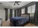 Comfortable bedroom with neutral colors, and windows for natural light overlooking the screened-in patio at 4530 Roanoak Way, Palm Harbor, FL 34685