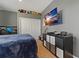 Neutral bedroom decor with ample storage featuring TV and decorative items on the shelf at 4530 Roanoak Way, Palm Harbor, FL 34685