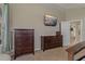 Bedroom featuring dark wood dresser, TV, neutral walls, and carpet at 4530 Roanoak Way, Palm Harbor, FL 34685