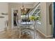 Cozy breakfast nook features a round table, white chairs, and bright view of the screened pool at 4530 Roanoak Way, Palm Harbor, FL 34685