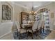 Formal dining room with a large table, elegant chandelier, and ample seating for gatherings at 4530 Roanoak Way, Palm Harbor, FL 34685