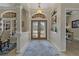 Inviting foyer with double doors, a decorative rug, and views into adjacent living spaces at 4530 Roanoak Way, Palm Harbor, FL 34685