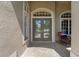 Elegant front door with decorative glass detailing, flanked by sidelights and a cozy porch at 4530 Roanoak Way, Palm Harbor, FL 34685