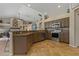 Open-concept kitchen boasts granite countertops, stainless steel appliances, and mocha cabinetry at 4530 Roanoak Way, Palm Harbor, FL 34685